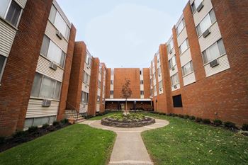 An exterior view of an apartment building with a courtyard